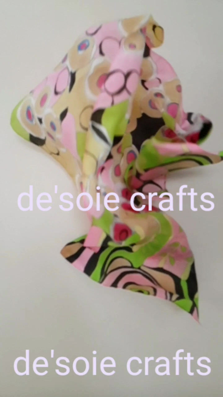 Thumbnail: Slow video of a hand painted pink stole with black and green and red & silver circles in an abstract design cascading down