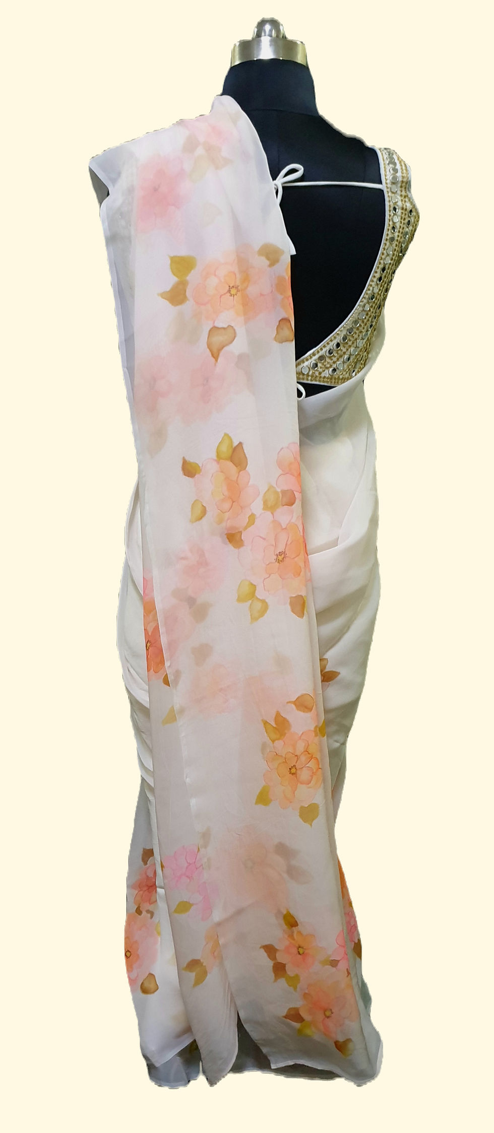 Thumbnail: Pastel pink silk organza saree hand painted in colors of Pink and Orange and Brown with Dahlia flowers draped on a mannequin