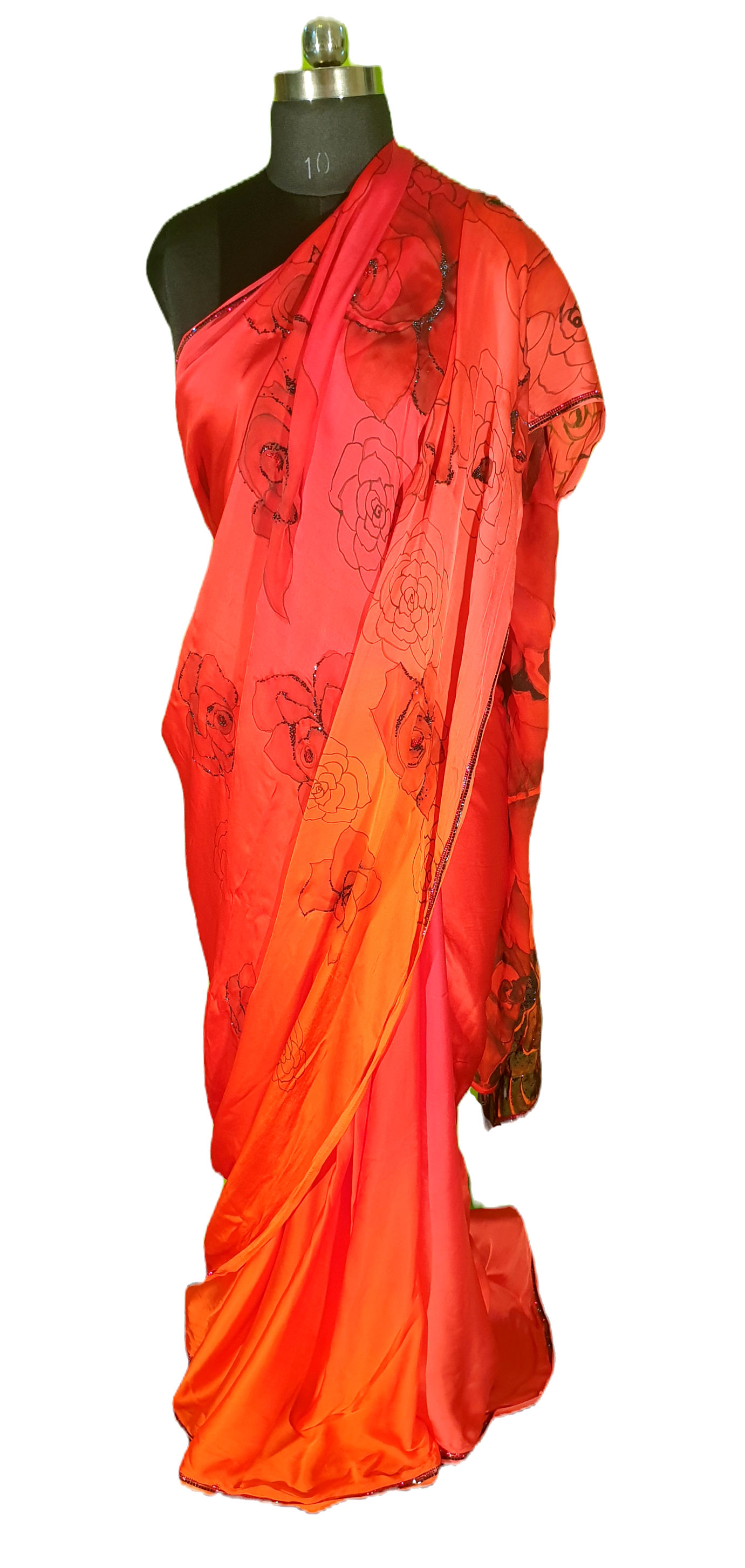 Reddish Orange satin georgette saree hand painted with black roses, highlighted with crystal stone and draped on a mannequin