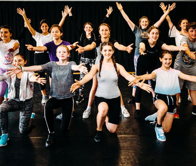 Young performers taking part in musical theatre training