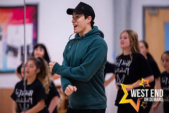 Young performers dancing with a teacher from West End on Demand