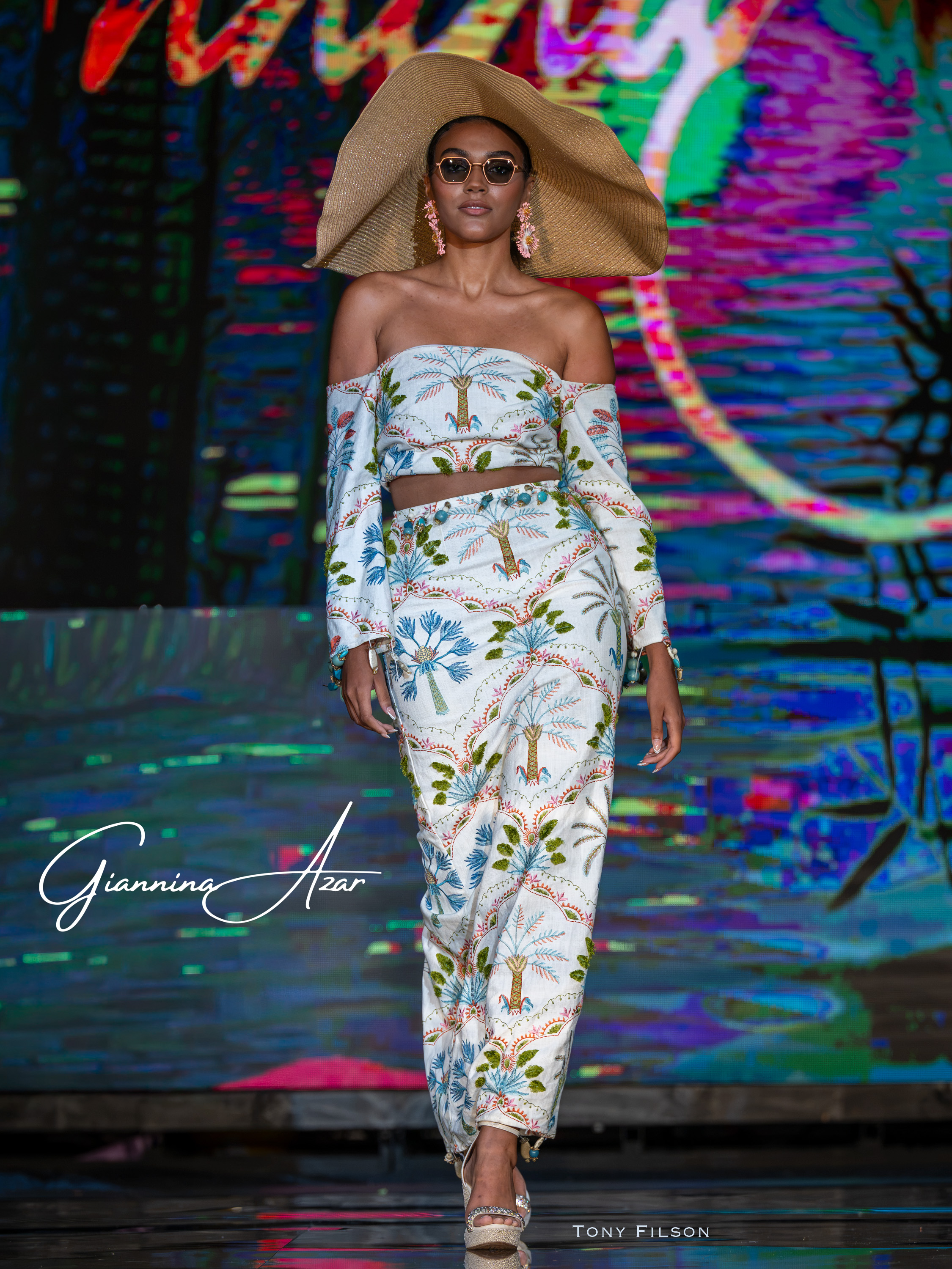 Resort Couture by Fashion Designer Giannina Azar on the Miami Swim Week Runway.  Large Sun Hat, tailored skirt and halter top with sleeves. This stunning ensemble was showcased at ClubM2 show in Miami for 2026.  Show produced by Art Hearts Fashion and photography by Tony Filson.  