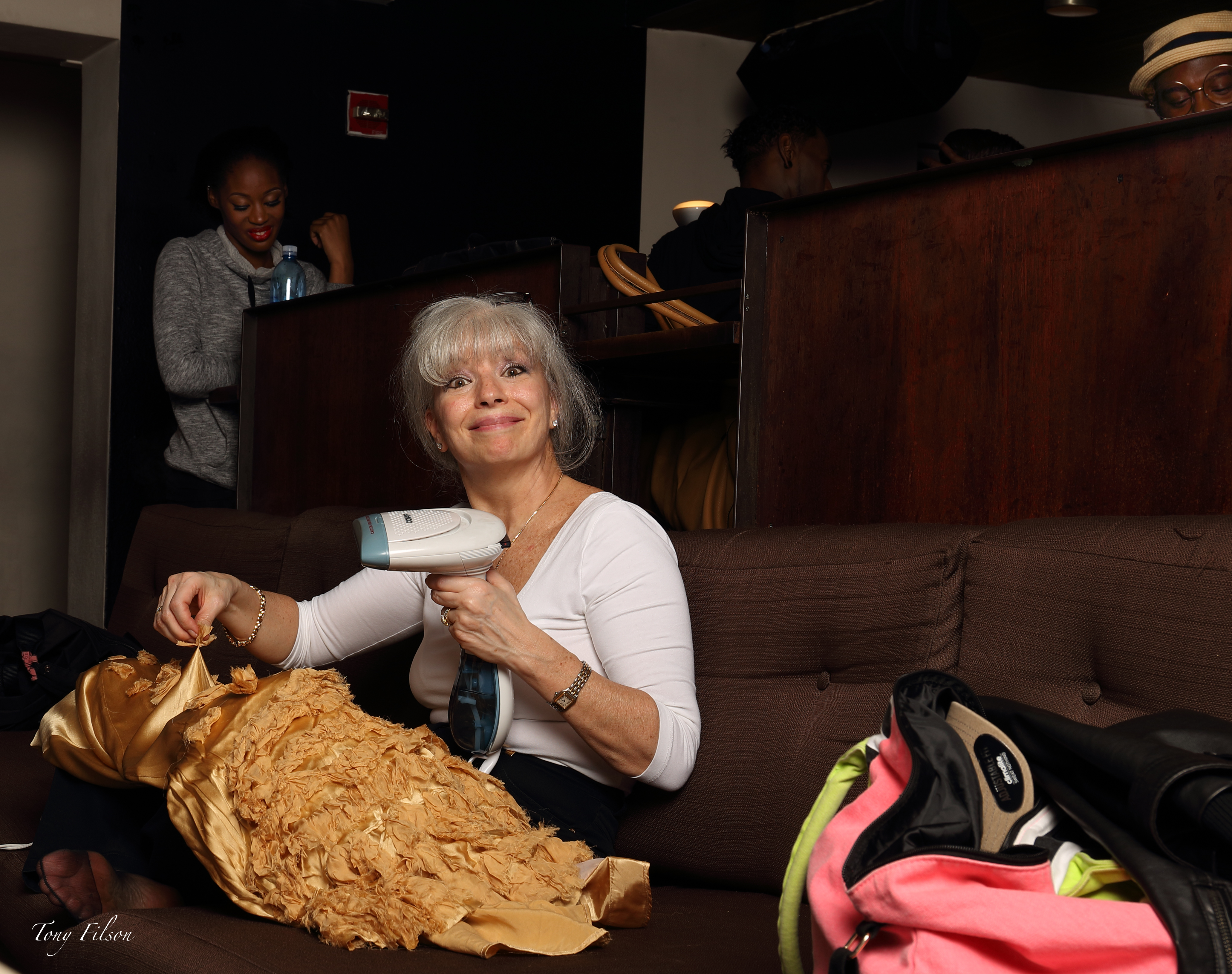 Helene is steaming a PopImpressKA Gold Silk Gown for a show to Open NYFW