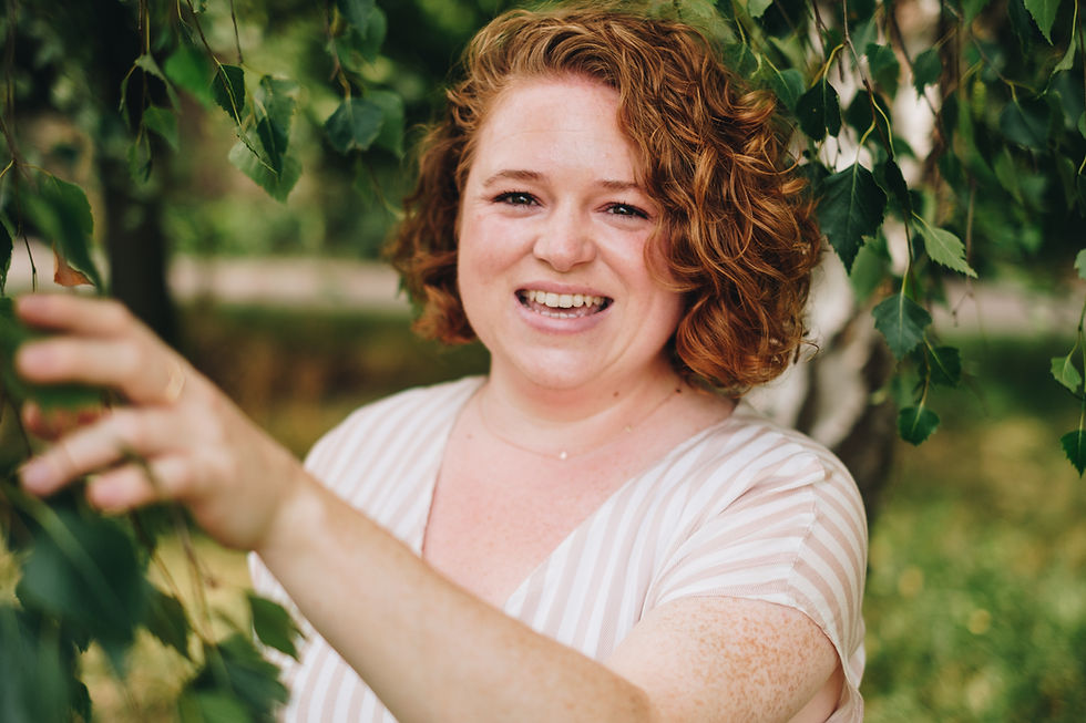 female business owner standing next to a tree