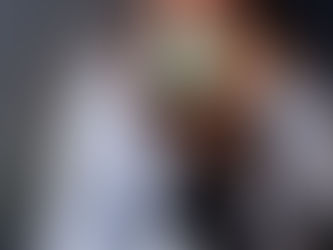 amanda hughes white female long dark brown hair sipping a mug looking out the window