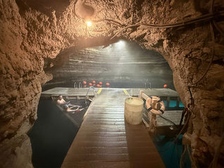 Cave entrance showing an underground pool with platform