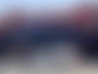 red brick saloon with white car parked outside