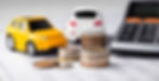 toy car next to coins and a calculator 