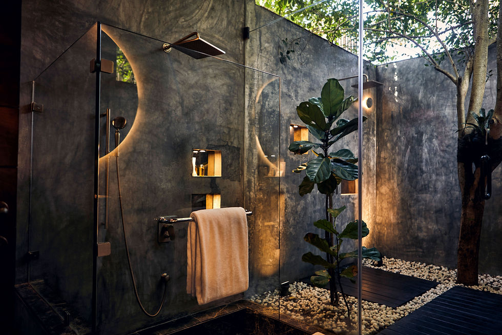 Luxurious shower with trees, mirror, and towel. Natural light illuminates the space.