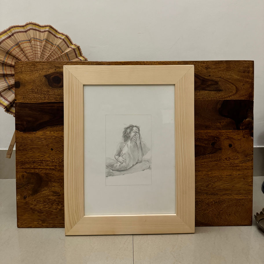 Framed portrait sketch on a wooden box