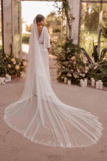 Floral embroidered cathedral veil by Sophie Raval, with the model looking over her shoulder