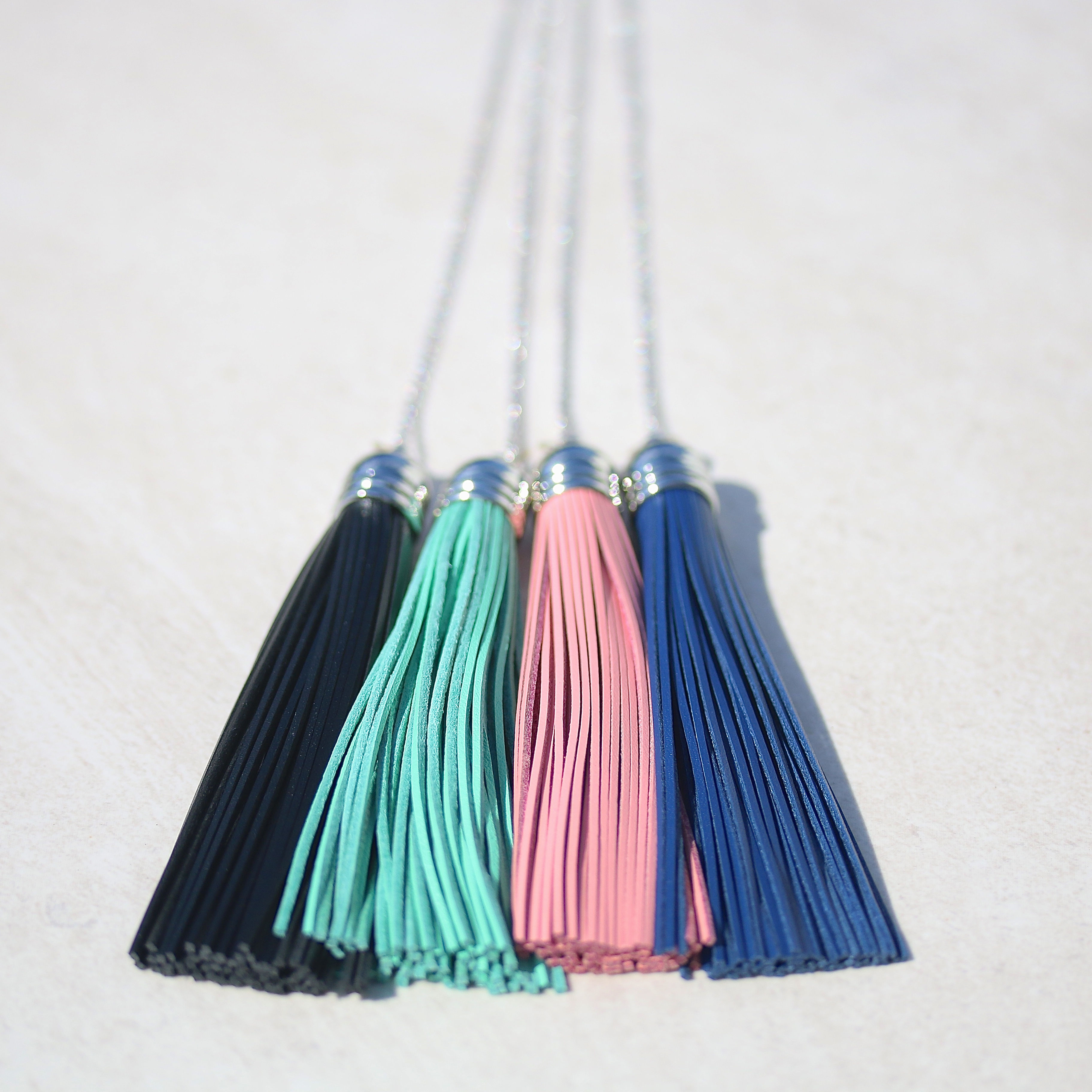 Long silver necklace with leather tassel
