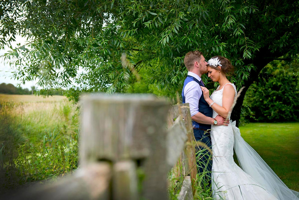 Newly wed couple pictured in a meadow