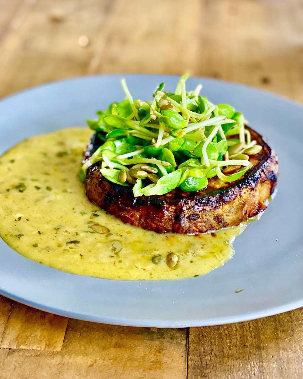 CELERY ROOT STEAK WITH CAFE DE PARIS SAUCE.