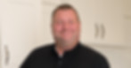 man standing in cabinet showroom wearing black polo