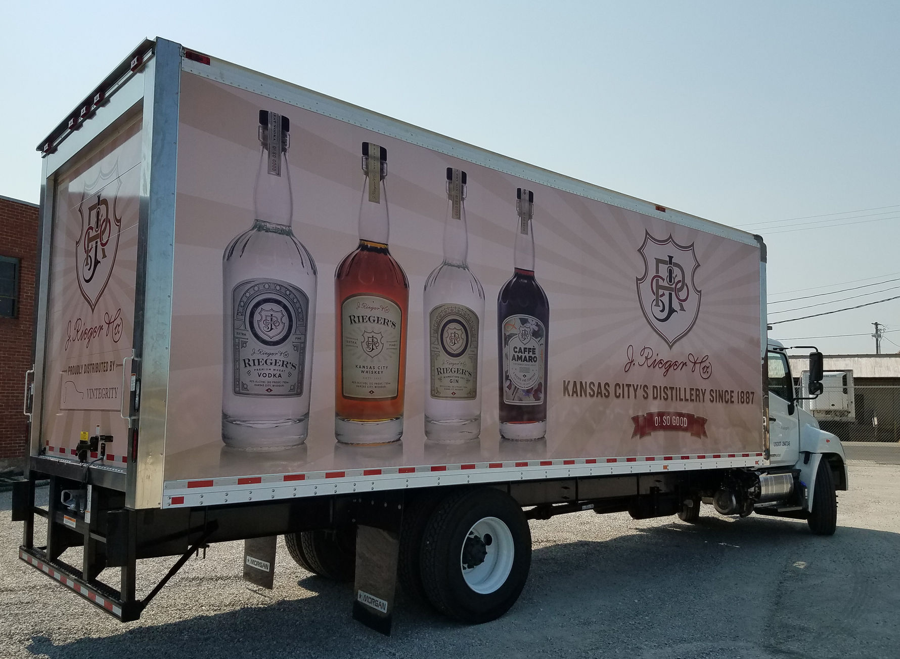 Box truck with liquor bottle graphics for advertising various spirits.