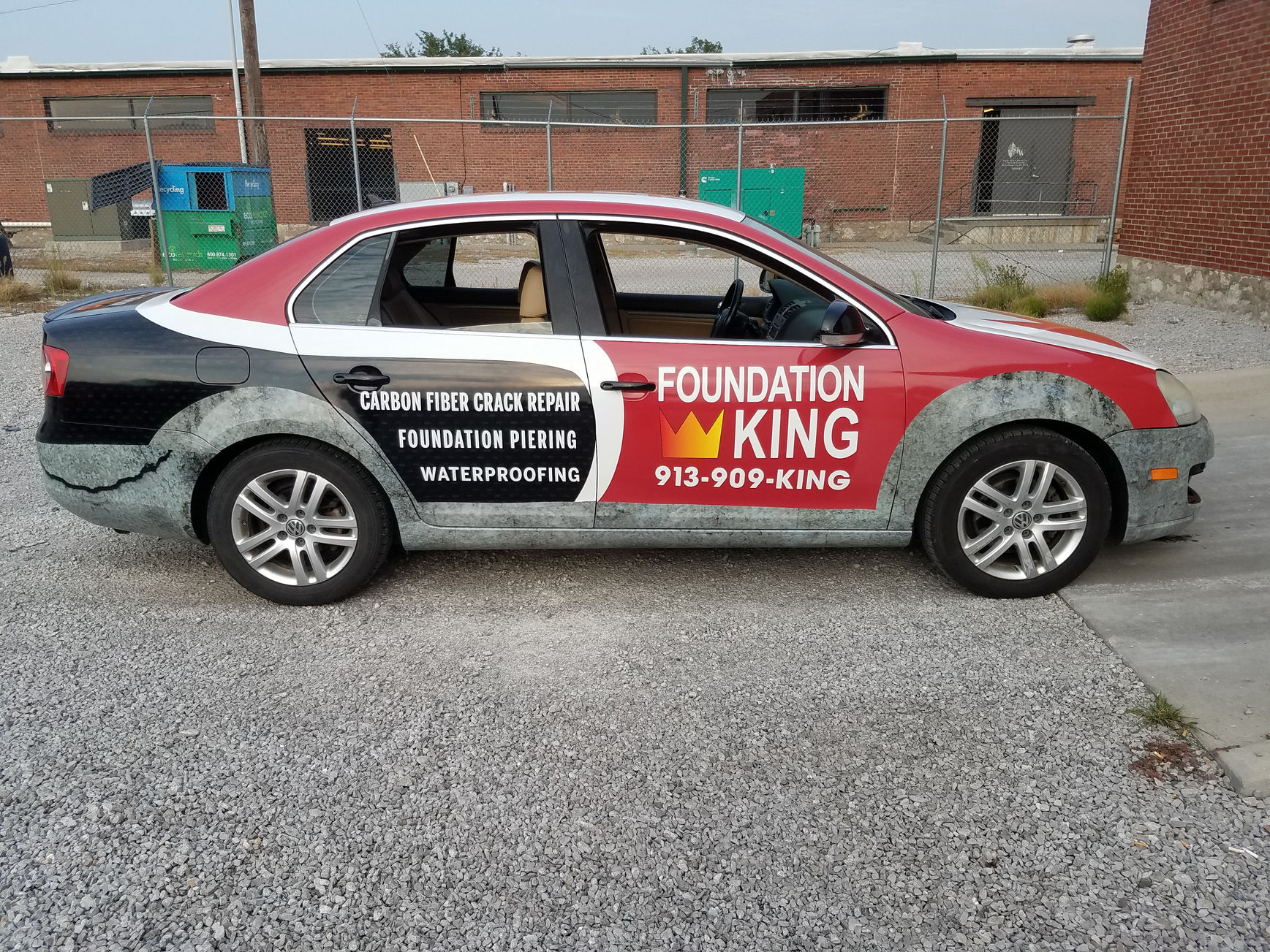 Red and white Foundation King car with visible business advertising and text.