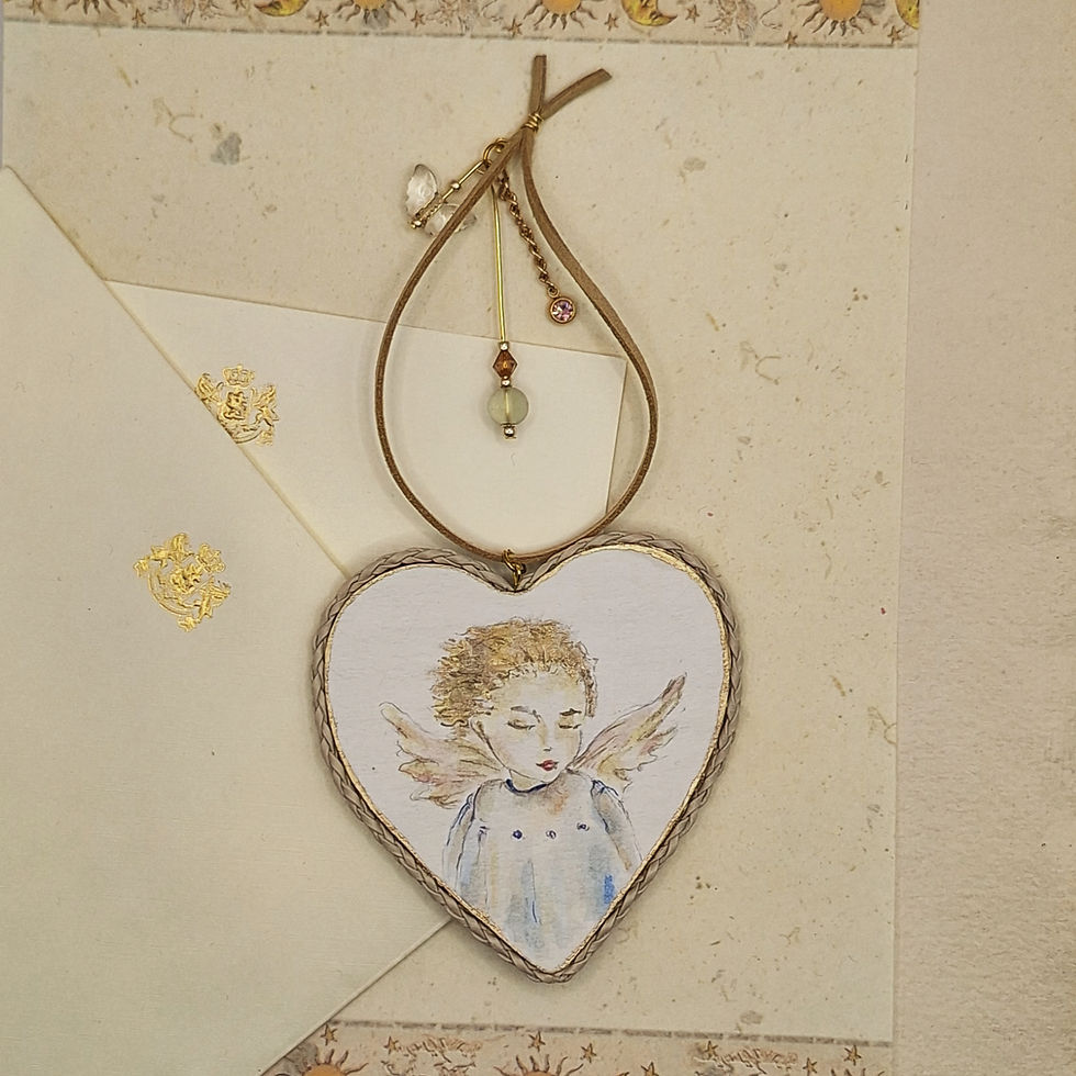Heart-shaped recycled cardboard ornament with hand-painted Baby Amour and rope with jewelry charm.
