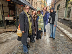 Team members stand for a posed picture on a street in Stockholm in winter.