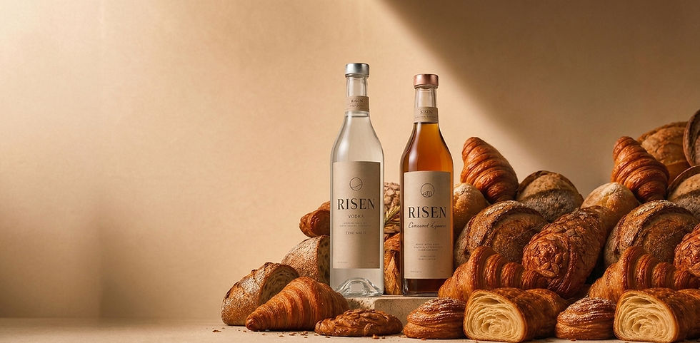 Risen Bottles with croissant and bread, the ingredients used to make the spirits.