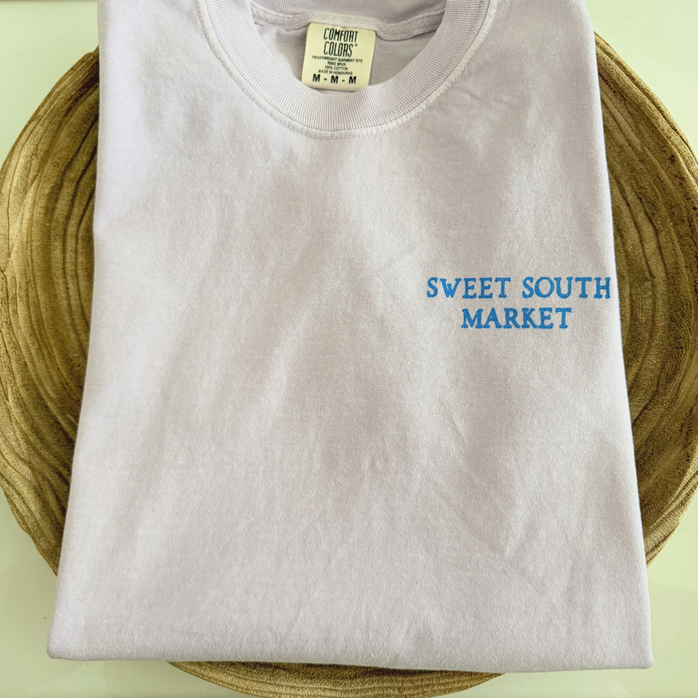 White t-shirt with text reading “Sweet South Market,” and Sweet South.