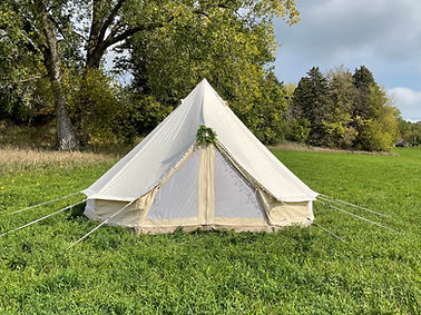 Luxury backyard glamping tent rental with rugs, pillows, and string lights by JL Events, Planning & Rentals in Buffalo NY