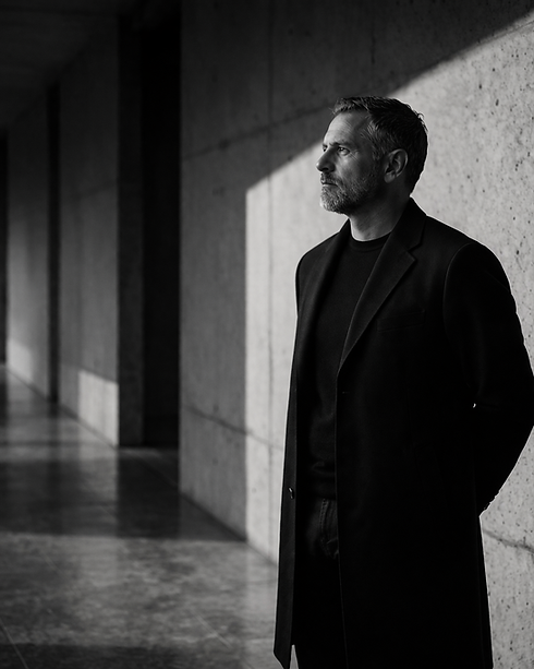 Thoughtful man in coat, reflecting leadership resilience