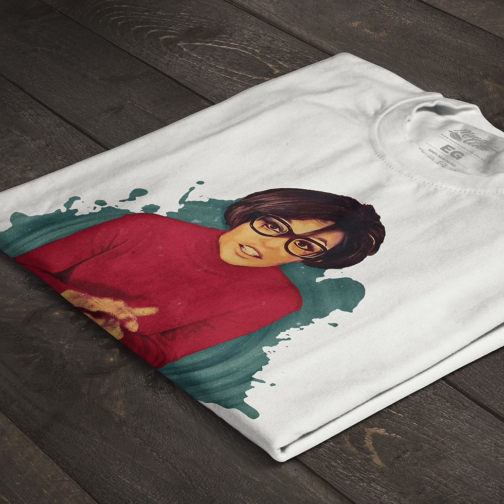 Miniatura: Camiseta branca dobrada, exibindo parte da estampa com cores vibrantes, homenageando Miriam Batucada.