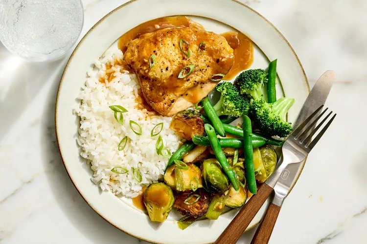Maple syrup, soy sauce, ginger, and garlic come together in this simple slow cooker chicken dish with crisped skin and caramelized brussels sprouts.