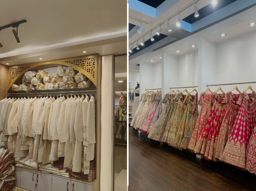 Indian wedding shopping store showcasing cream sherwanis with turbans on display and vibrant bridal lehengas in red, pink, and gold hanging in a boutique.