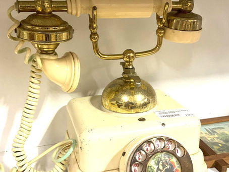 Antique rotary phone with gold accents
