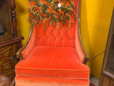 Vintage orange upholstered chair with handmade blanket
