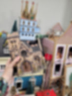 person holding up Lemax village piece