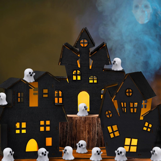Black haunted house with ghost figurines