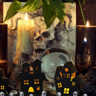 Halloween setup with skull art and candle