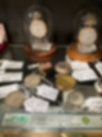 Antique mall case with pocket watches and mantel clocks