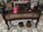 Vintage caned short bench with carved legs