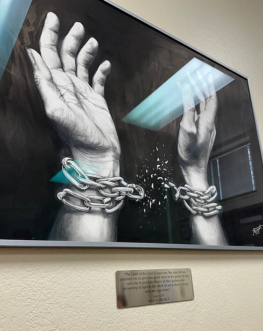framed drawing of hands with chains shattering hanging in shelter kc in kansas city missou