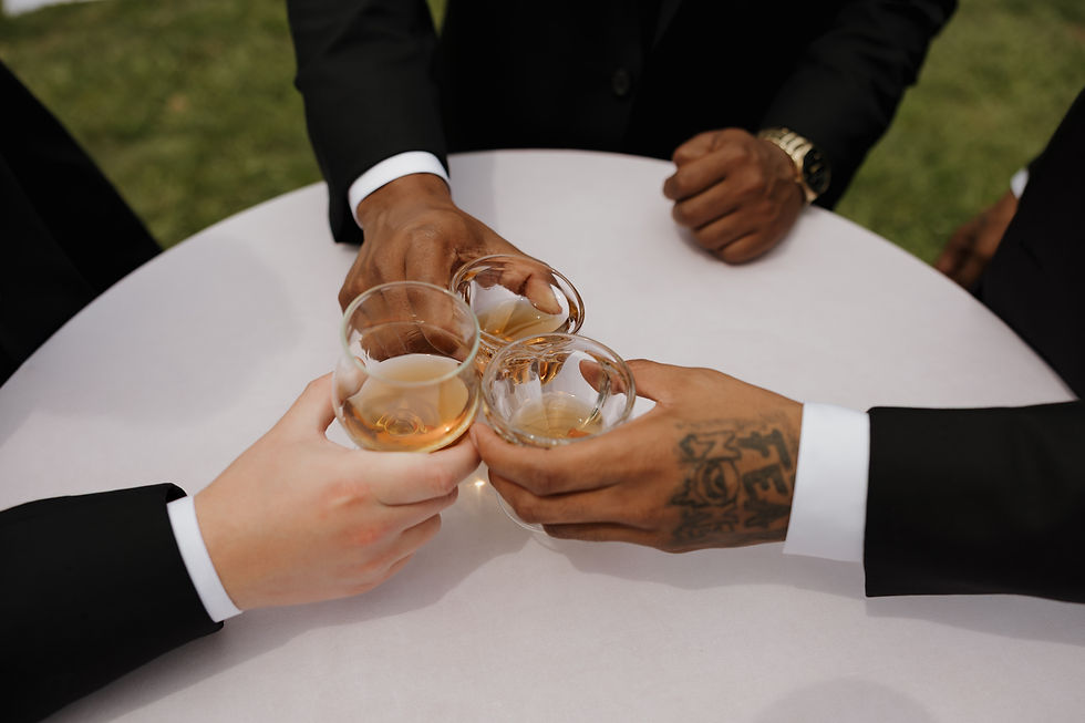 Eye-level view of a bartender preparing cocktails at a wedding bar