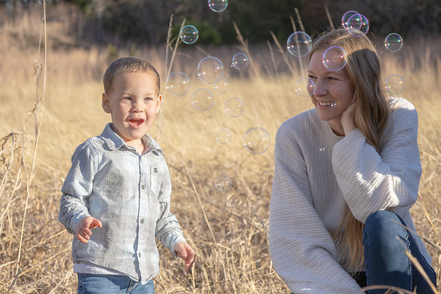 Jessica Brittani, founder of Calm & Colorful, blowing bubbles with her little one