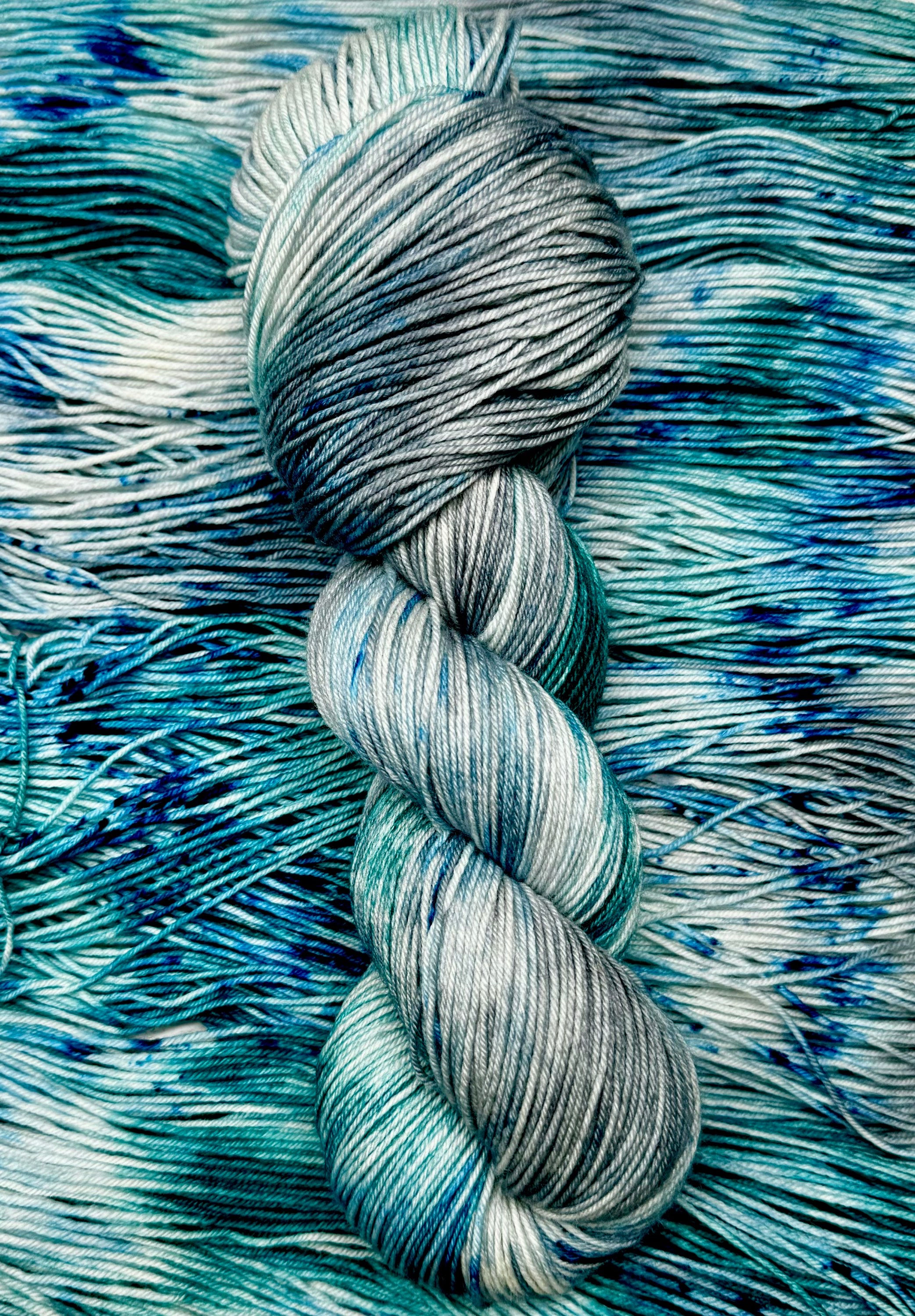 One skien of blue and teal variegated hand dyed yarn.