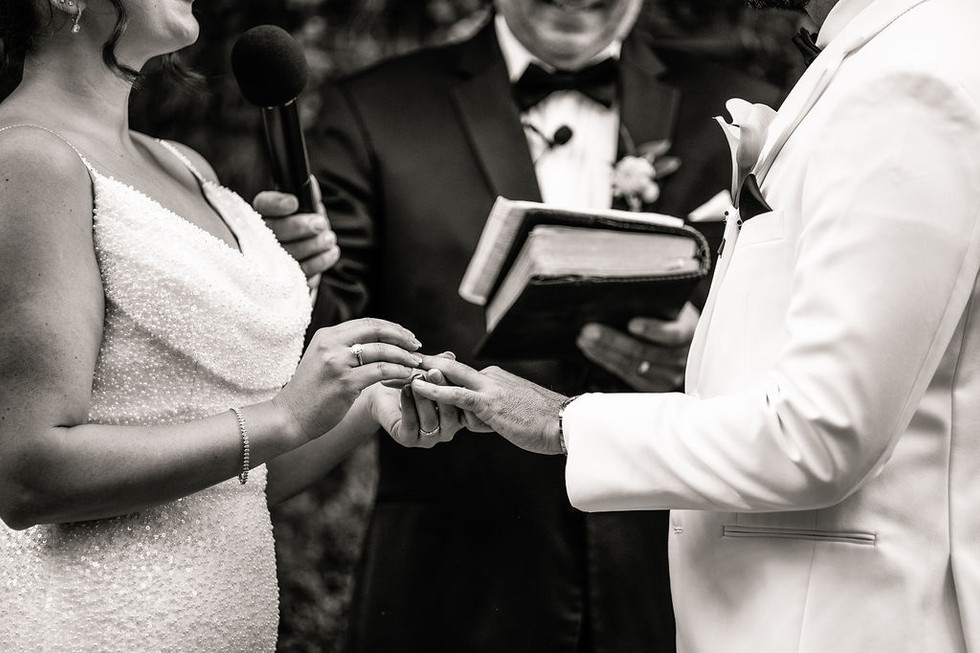 a bride putting on a grooms wedding ring at the altar at Excelsior in Lancaster Pennsylvania