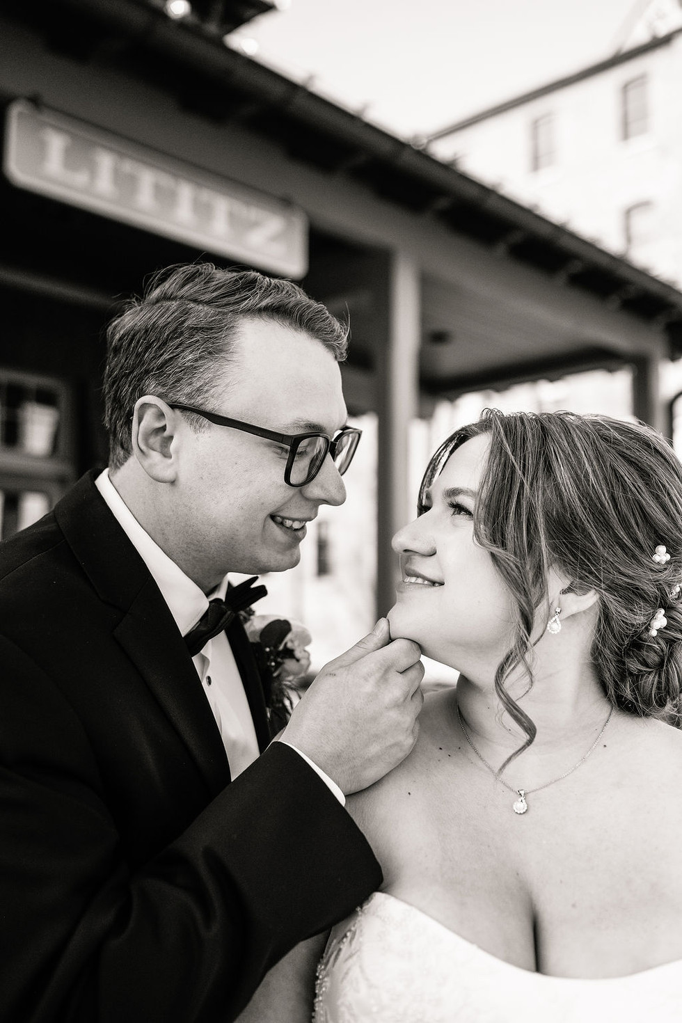 close-up of a groom holding the chin of his bride looking at each other Lititz Spring Park in Lititz Pennsylvania