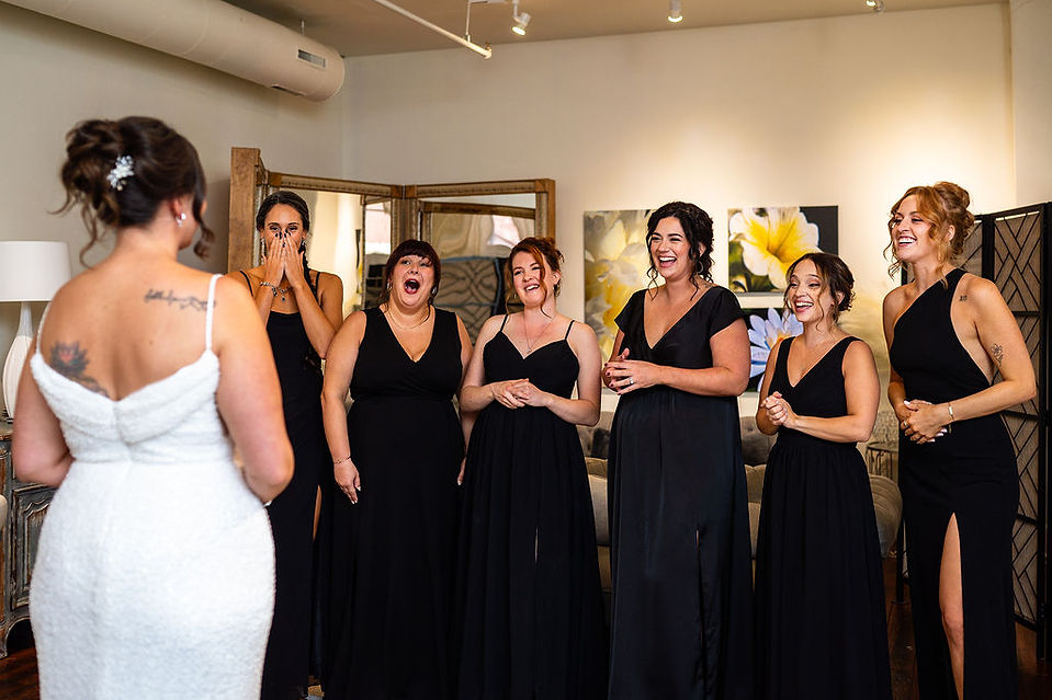 bridesmaids being surprised by bride in her wedding dress at Excelsior in Lancaster Pennsylvania