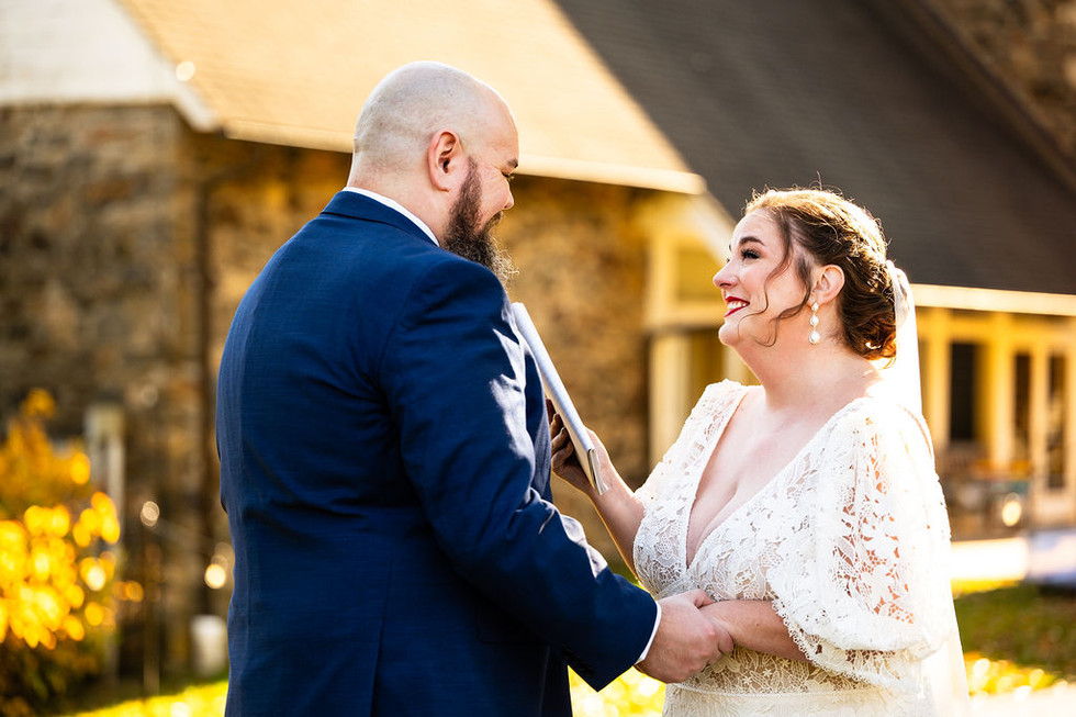 a bride and groom smiling at eah other at Tyler Arboretum in Media, Pennsylvania