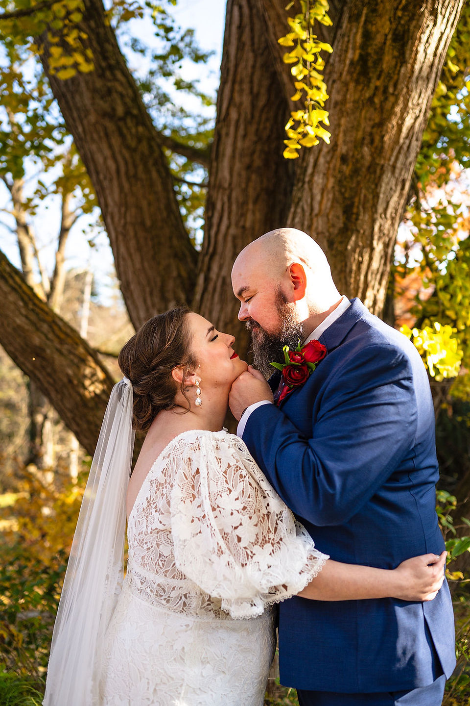 bride and groom embraced in front of a tree at Tyler Arboretum in Media, Pennsylvania