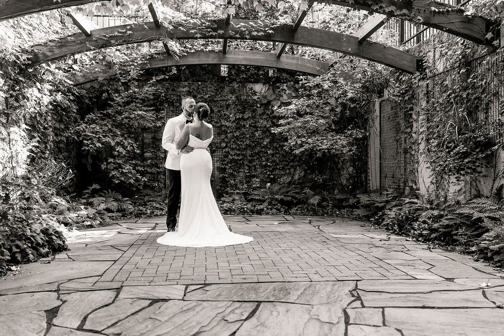 black and white image of a bride and groom dancing under a garden terrace at Excelsior in Lancaster Pennsylvania