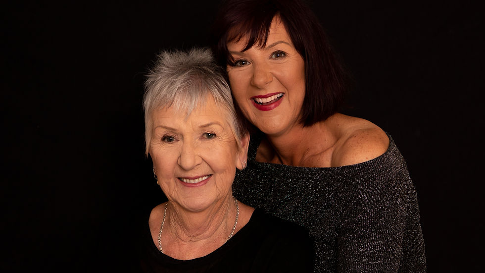 Studio portrait with intentional black wardrobe against a dark backdrop
