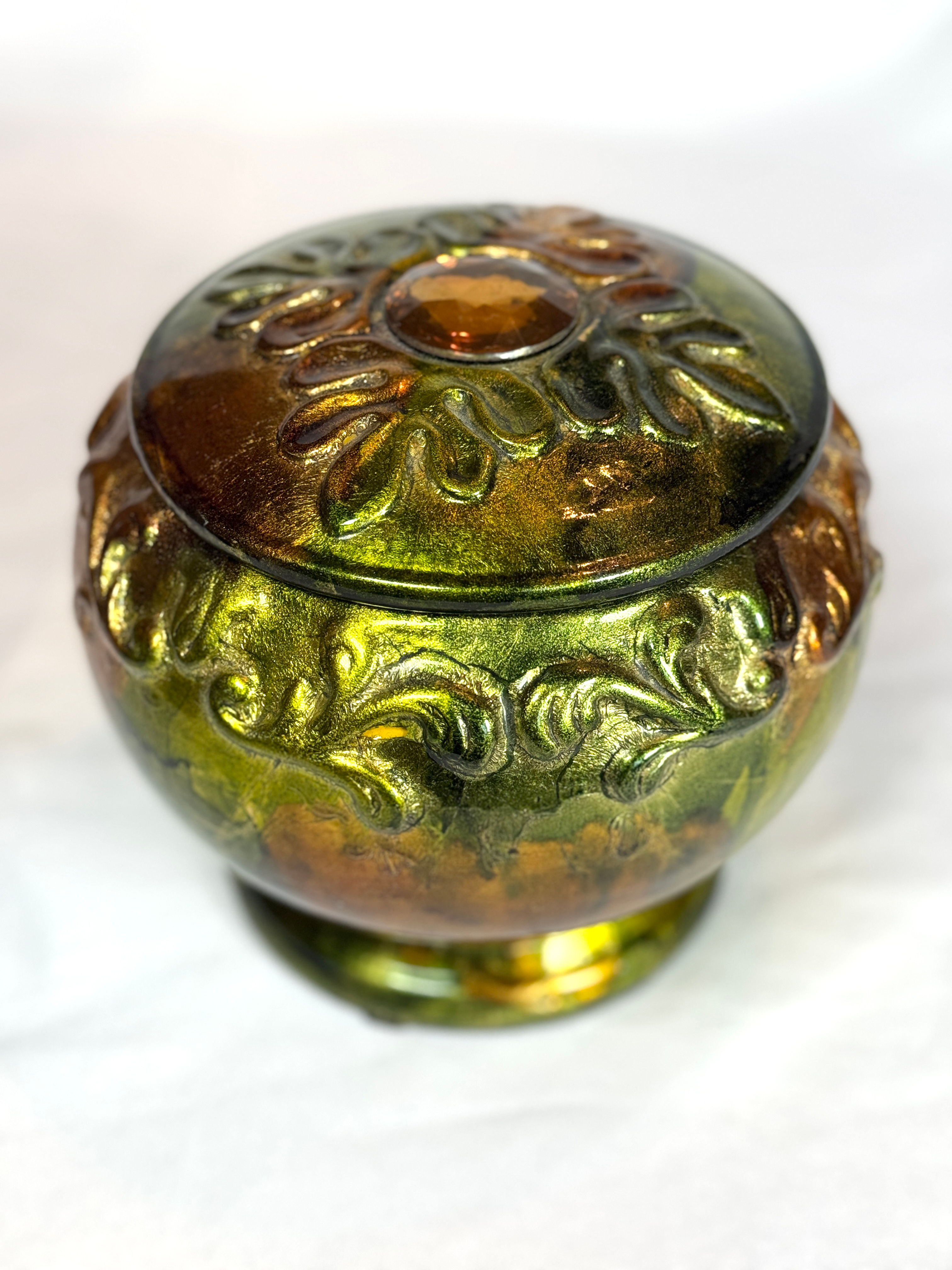 Footed green and amber color jar with lid