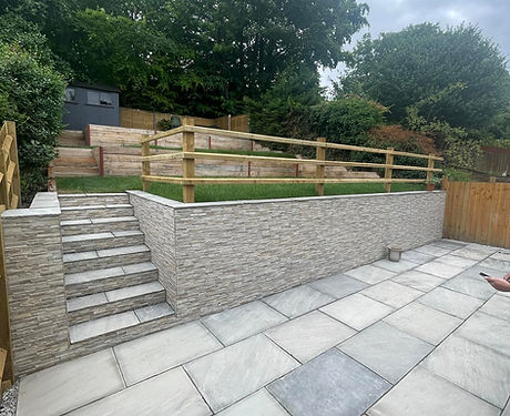 landscaped garden which has retaining walls and paving, plus turfing and fencing